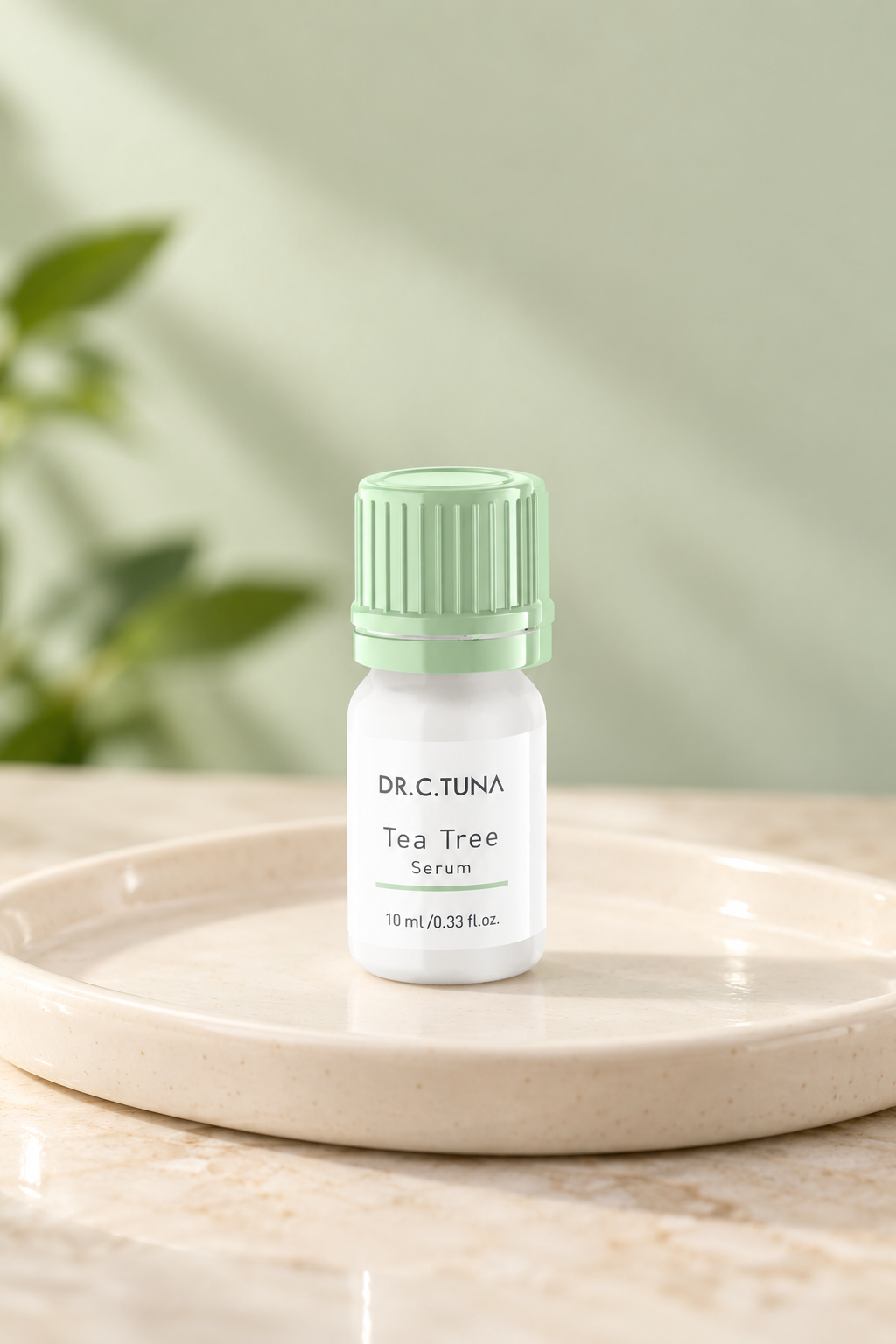 Farmasi Dr. C. Tuna Tea Tree Serum, 10 ml bottle with a mint green cap on a cream ceramic tray.