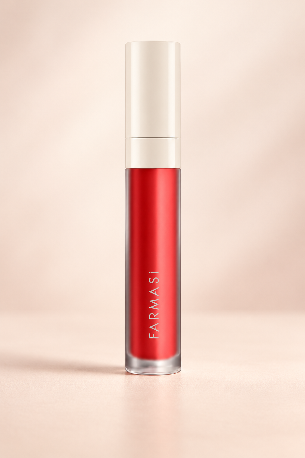 Farmasi LATINA Lip Lacquer in a red-coral shade with an ivory cap, photographed against a warm cream backdrop.