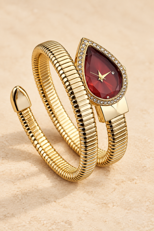 Gold-tone multi-wrap bracelet watch with a faceted ruby-red teardrop dial and crystal halo